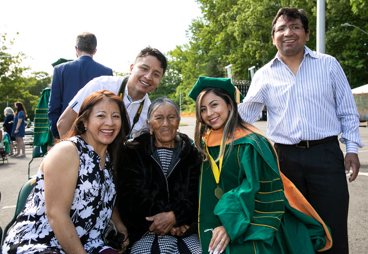 Graduating PhD student in regalia and family