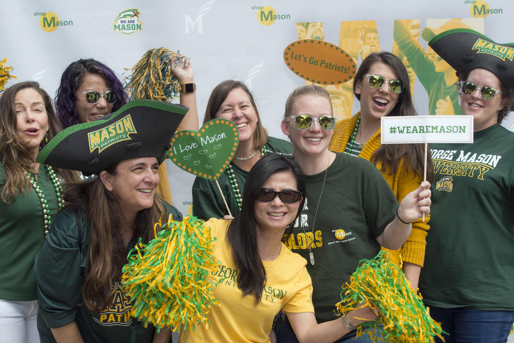 Mason graduate students in green and gold t-shirts